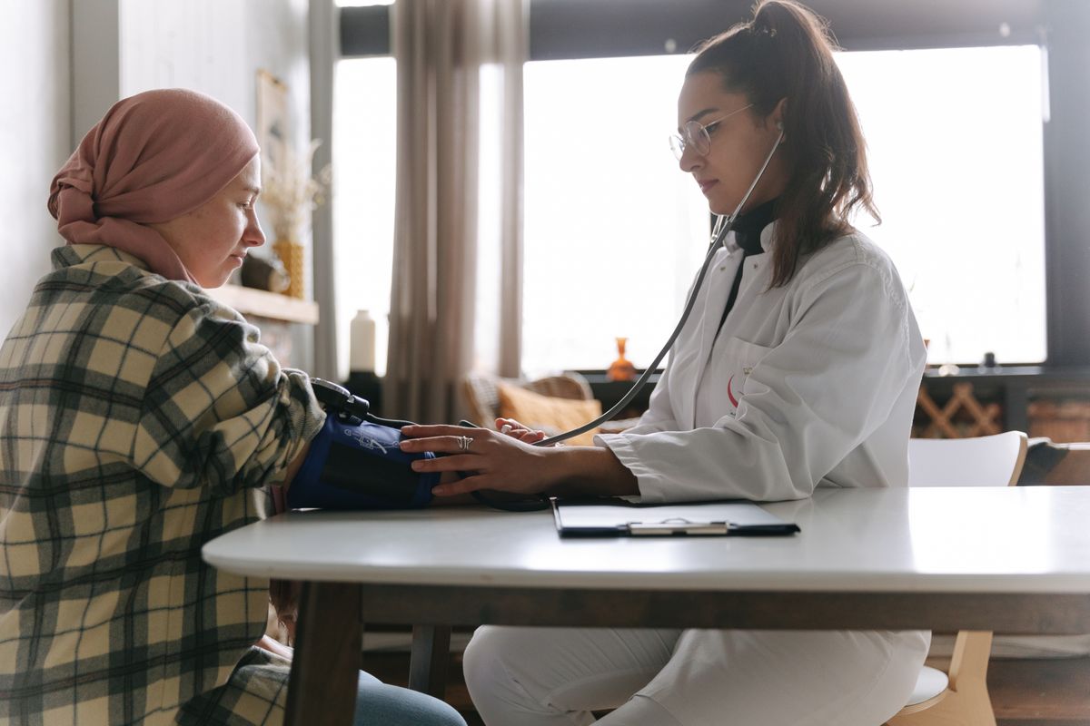 Doctor measuring a patient's blood pressure during a health screening