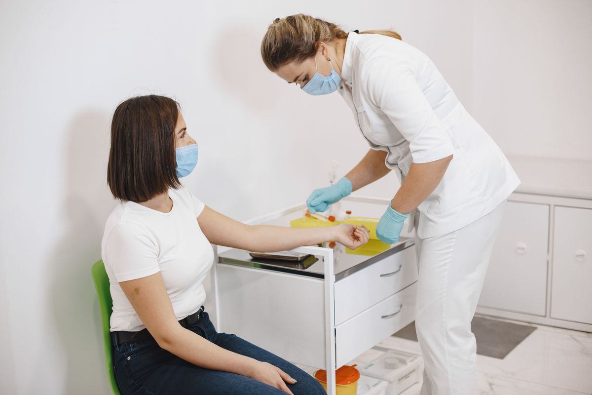Nurse administering a vaccination to a patient